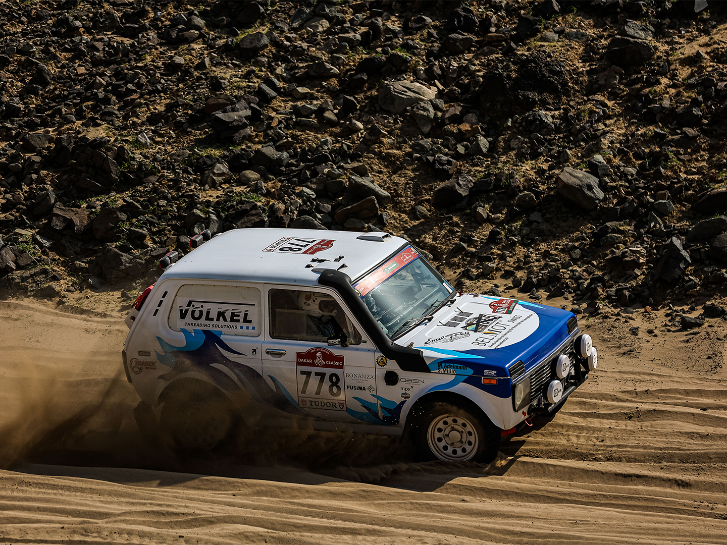 Close-up of tire and suspension in dust