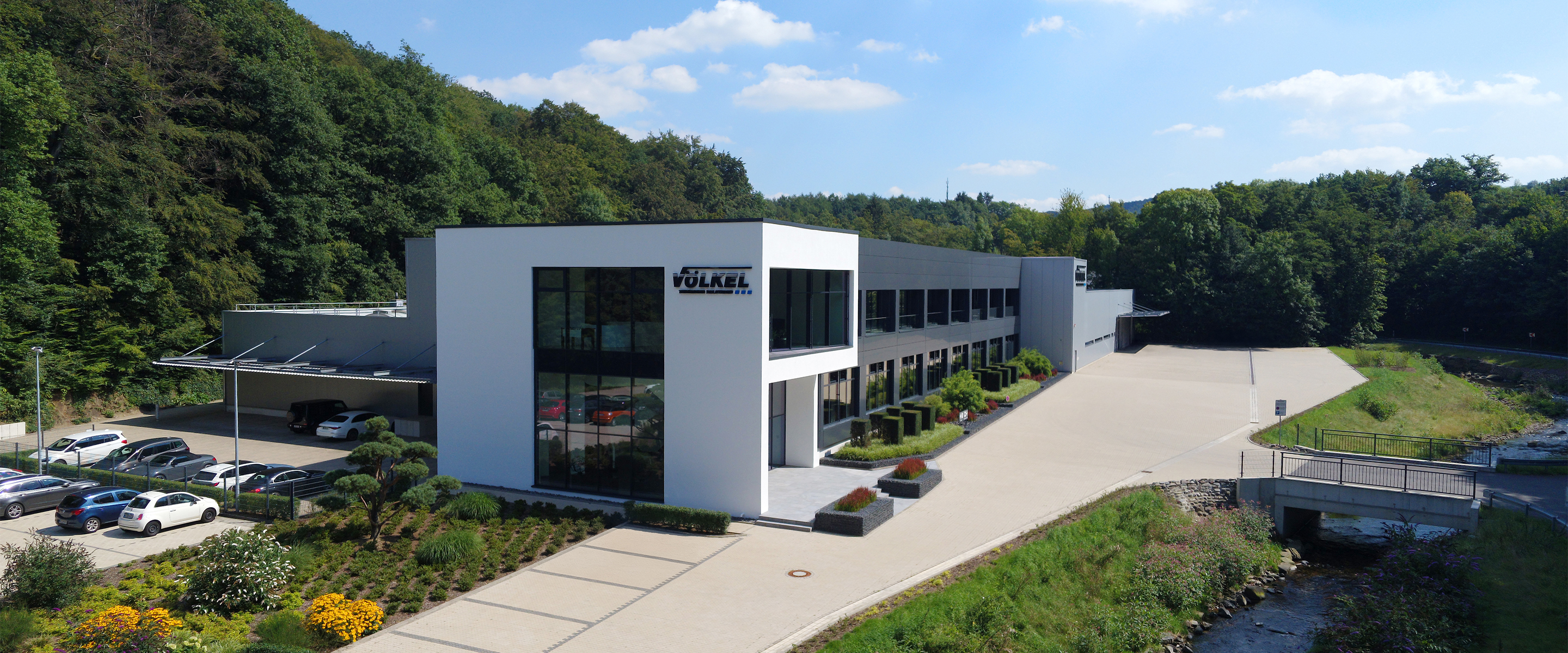 Völkel GmbH building with logo and nature in the background.