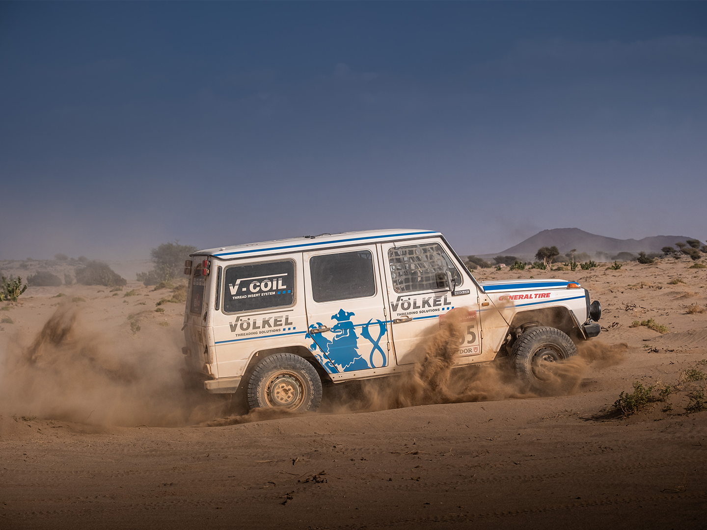 Off-road vehicle in vast desert landscape